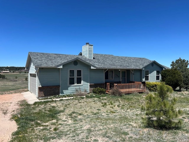 15840 Teak Pl, Elbert, CO 80106 - rear view of house featuring a shingled roof, a chimney, a porch, and brick siding