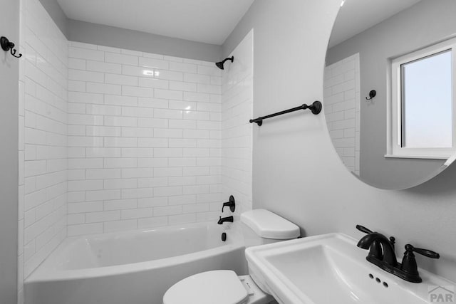 full bath featuring shower / tub combination, a sink, and toilet