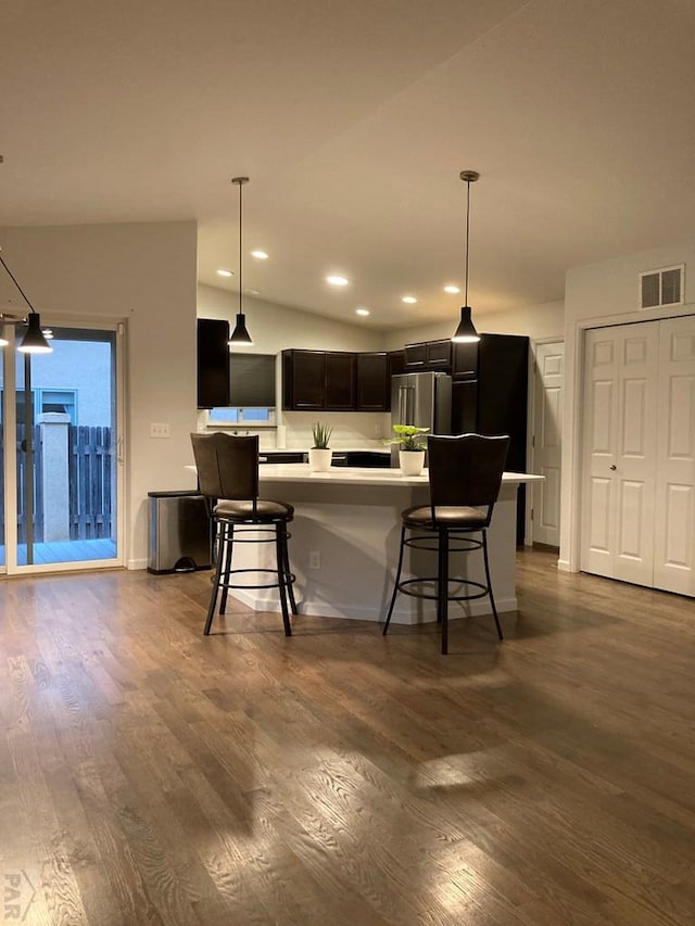 47 S Jibbsam Way, Pueblo West, CO 81007 - kitchen with dark wood finished floors, light countertops, a kitchen breakfast bar, and recessed lighting