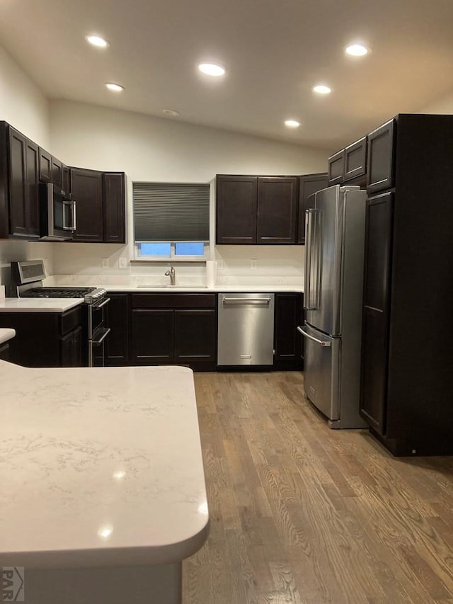 47 S Jibbsam Way, Pueblo West, CO 81007 - kitchen with appliances with stainless steel finishes, light wood-style floors, recessed lighting, and dark brown cabinetry