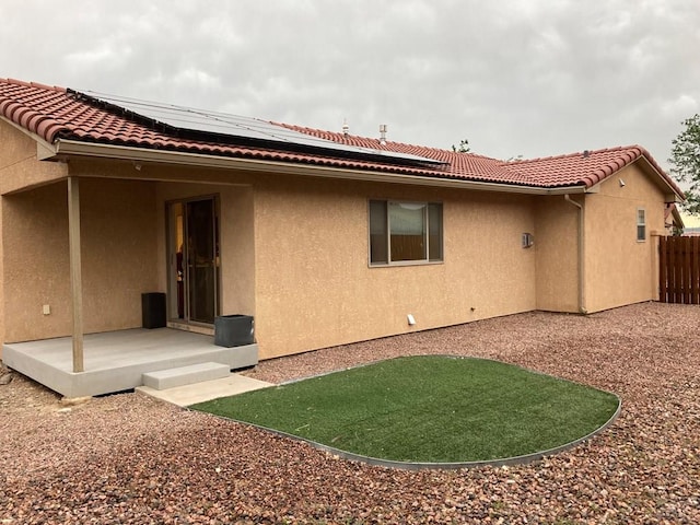 47 S Jibbsam Way, Pueblo West, CO 81007 - rear view of house with stucco siding, roof mounted solar panels, and a tile roof