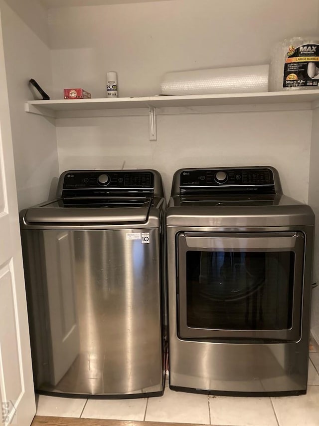 47 S Jibbsam Way, Pueblo West, CO 81007 - laundry area with light tile patterned flooring and washing machine and clothes dryer