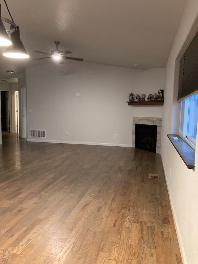 47 S Jibbsam Way, Pueblo West, CO 81007 - unfurnished living room featuring wood finished floors, a fireplace, and a ceiling fan