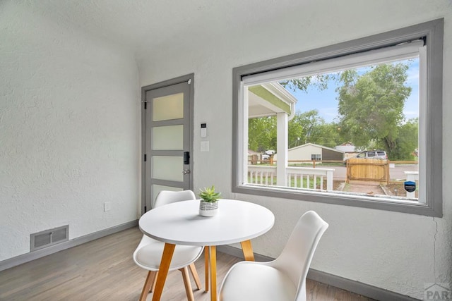 411 Olive St, Colorado Springs, CO 80904 - dining space with a textured wall, wood finished floors, and baseboards