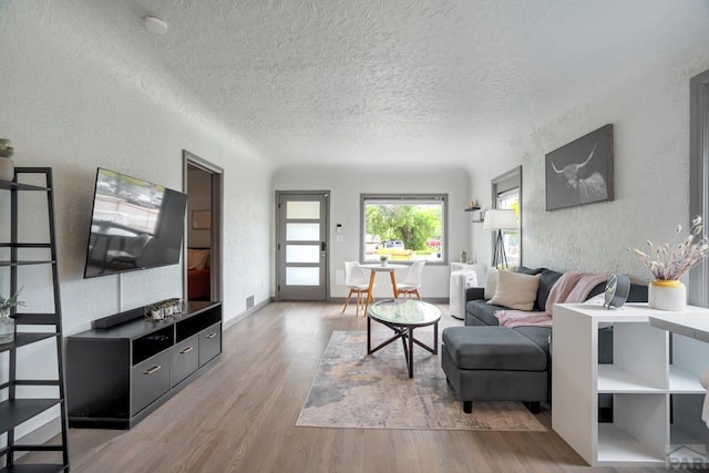 411 Olive St, Colorado Springs, CO 80904 - living area featuring a textured wall, wood finished floors, and a textured ceiling