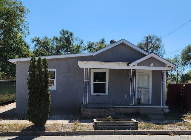 view of front of property featuring fence and stucco siding