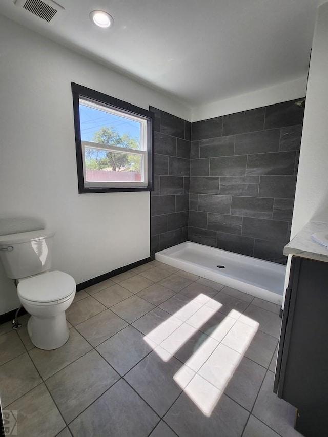 full bathroom with visible vents, toilet, a shower stall, vanity, and tile patterned floors