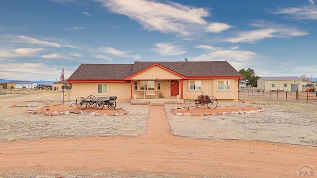 view of front of house featuring fence