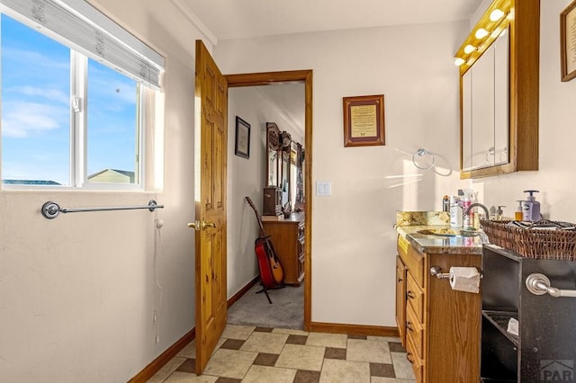 bathroom featuring tile patterned floors, baseboards, and vanity