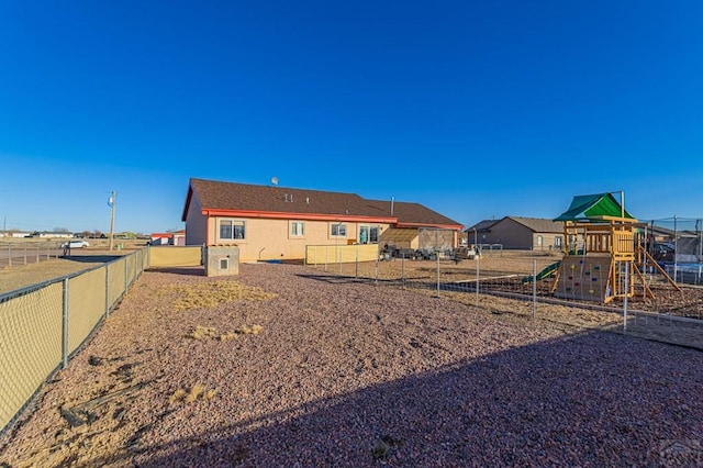 view of yard with fence and a playground