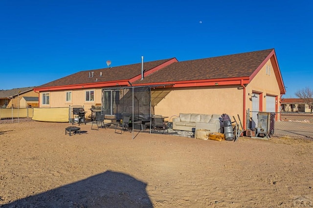 back of property with stucco siding, a patio, a garage, and fence