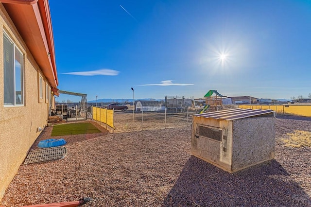 view of yard with a playground and fence