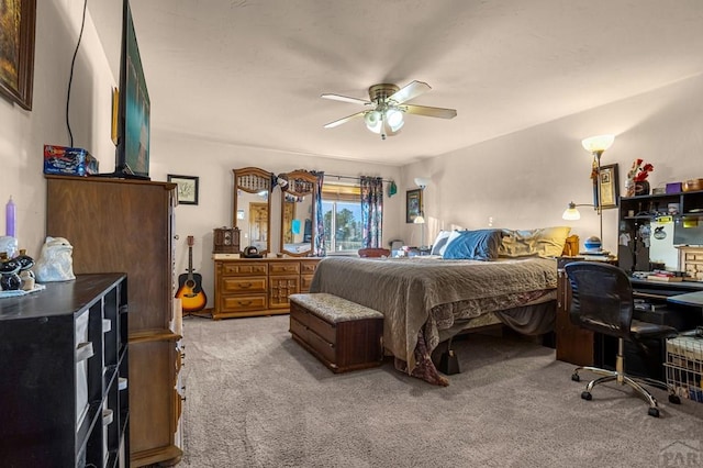 bedroom featuring light carpet and a ceiling fan