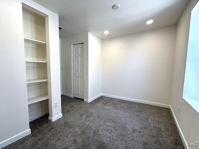 1016 E 10th St, Pueblo, CO 81001 - unfurnished bedroom featuring recessed lighting, baseboards, and dark colored carpet