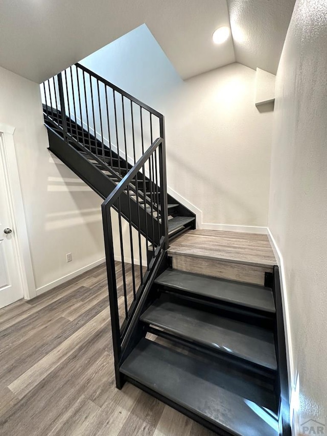 1016 E 10th St, Pueblo, CO 81001 - stairway with vaulted ceiling, recessed lighting, baseboards, and wood finished floors
