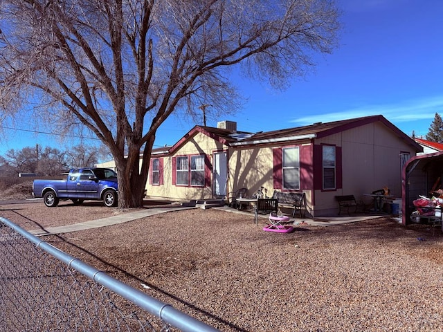 view of front of property with cooling unit and a patio