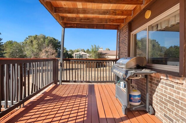 wooden deck with a grill