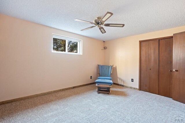 unfurnished room with a ceiling fan, carpet, a textured ceiling, and baseboards