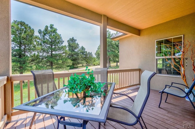 wooden terrace featuring outdoor dining space