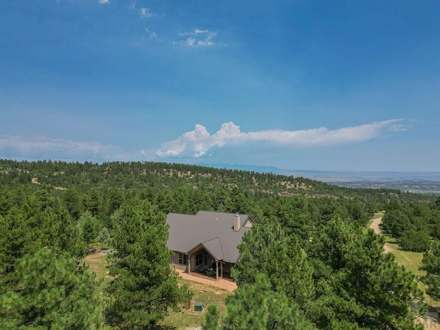 birds eye view of property with a forest view