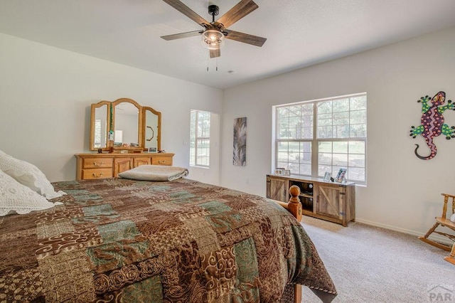 bedroom with light carpet, ceiling fan, and baseboards