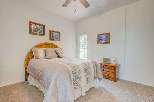 carpeted bedroom with ceiling fan and baseboards