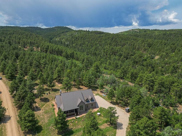 birds eye view of property featuring a forest view and a mountain view