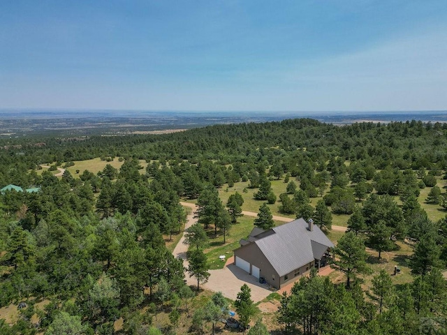 birds eye view of property featuring a view of trees