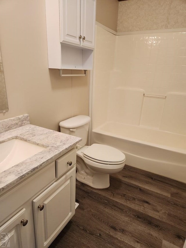 6464 Dillon Dr Unit 11, Pueblo, CO 81008 - bathroom with shower / bathing tub combination, vanity, toilet, and wood finished floors