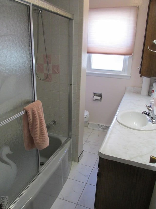 1520 Lexington Rd, Pueblo, CO 81001 - full bath with visible vents, toilet, vanity, shower / bath combination with glass door, and marble finish floor