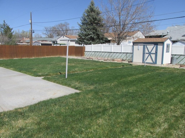 1520 Lexington Rd, Pueblo, CO 81001 - view of yard featuring a fenced backyard, an outdoor structure, and a storage unit