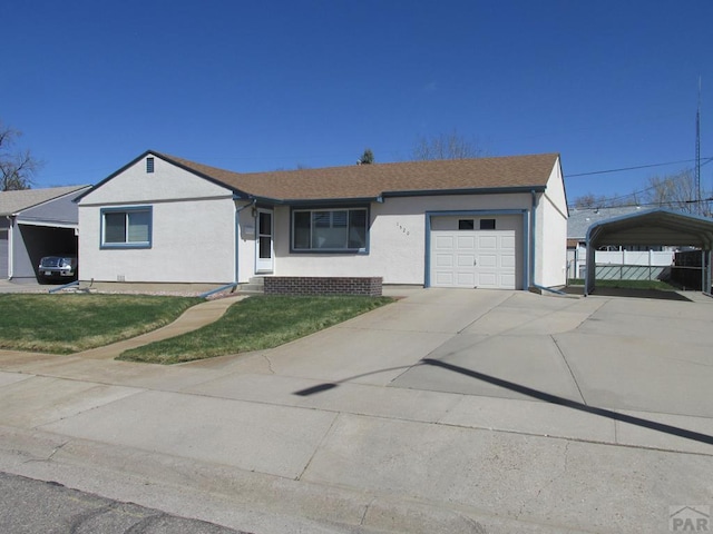 1520 Lexington Rd, Pueblo, CO 81001 - ranch-style house featuring a garage, stucco siding, a carport, fence, and concrete driveway
