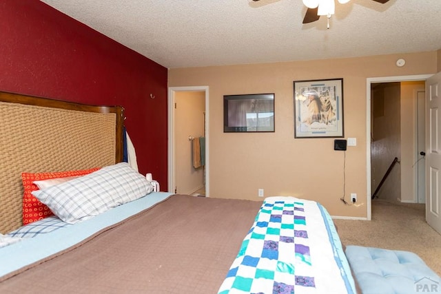 carpeted bedroom featuring a textured ceiling, a ceiling fan, and baseboards