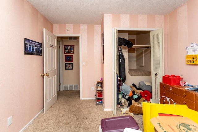 bedroom with baseboards, visible vents, a textured ceiling, and light colored carpet