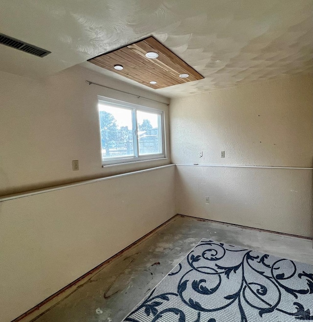 unfurnished room featuring visible vents and unfinished concrete floors