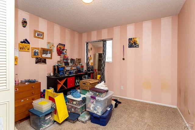 miscellaneous room with a textured ceiling, carpet, baseboards, and wallpapered walls