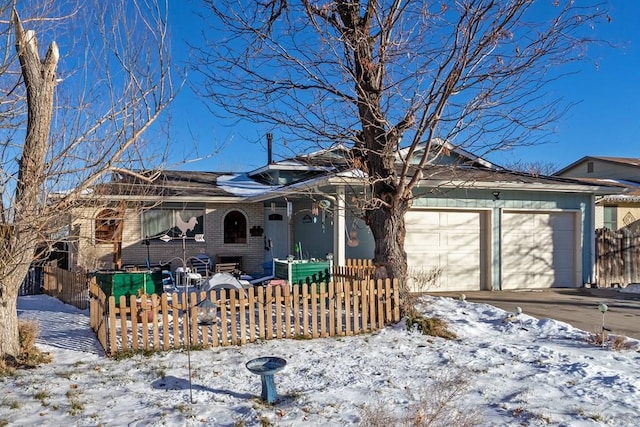 single story home with an attached garage, a fenced front yard, concrete driveway, and brick siding