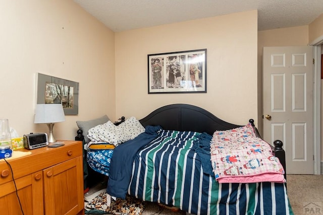 carpeted bedroom with a textured ceiling