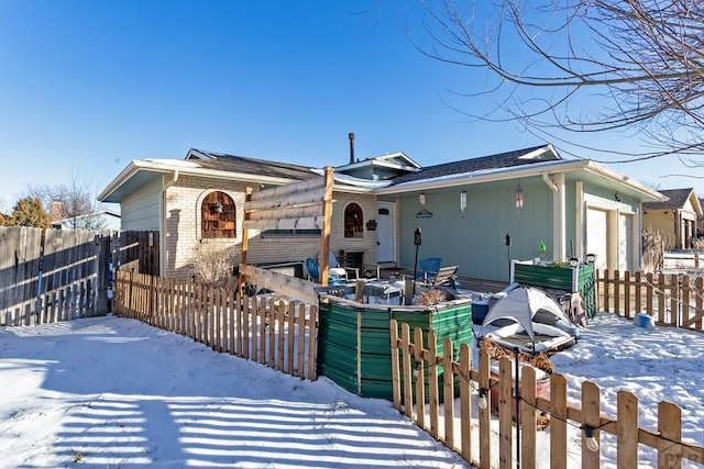 exterior space featuring brick siding and a fenced front yard