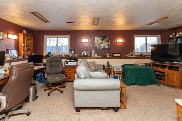 office space with plenty of natural light and light colored carpet