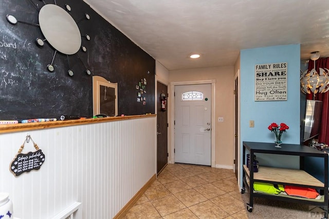 foyer entrance featuring light tile patterned floors and baseboards