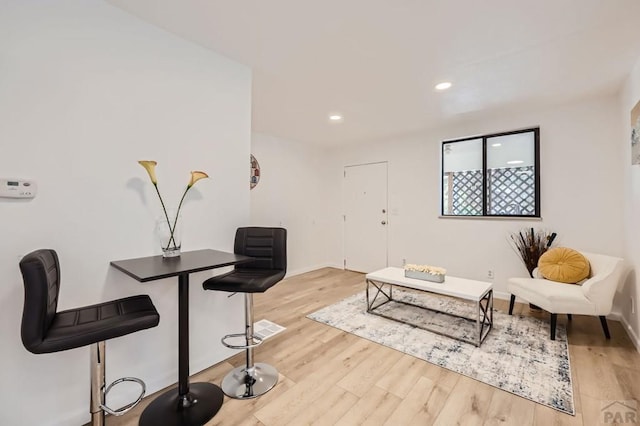 interior space featuring baseboards, light wood-style flooring, and recessed lighting