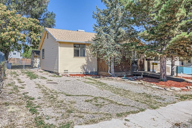 view of front of home featuring fence and roof with shingles