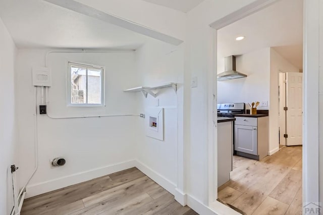 laundry room featuring light wood finished floors, baseboards, laundry area, and washer hookup