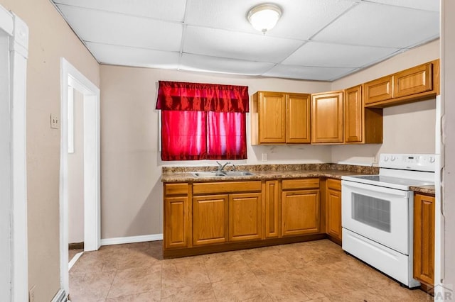 935 Spruce St, Pueblo, CO 81005 - kitchen with white electric range, a drop ceiling, brown cabinets, and dark countertops