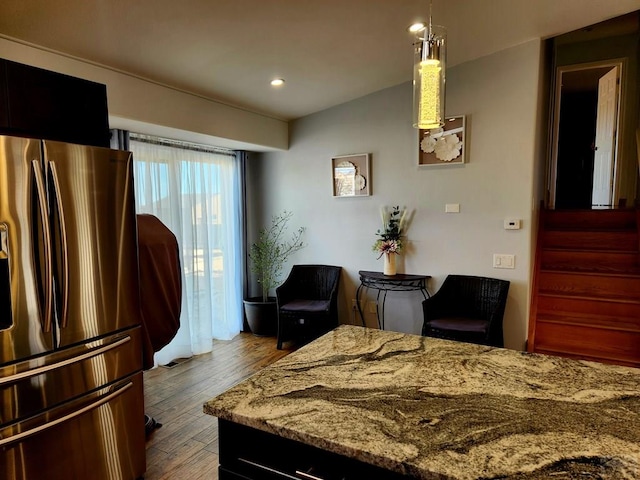1044 S Los Charros Dr, Pueblo West, CO 81007 - bedroom with vaulted ceiling, recessed lighting, wood finished floors, and stainless steel fridge with ice dispenser