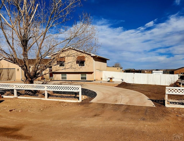 1044 S Los Charros Dr, Pueblo West, CO 81007 - view of yard featuring fence and driveway