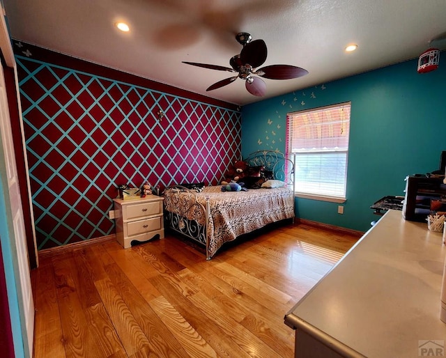1044 S Los Charros Dr, Pueblo West, CO 81007 - bedroom with recessed lighting, an accent wall, baseboards, and wood finished floors