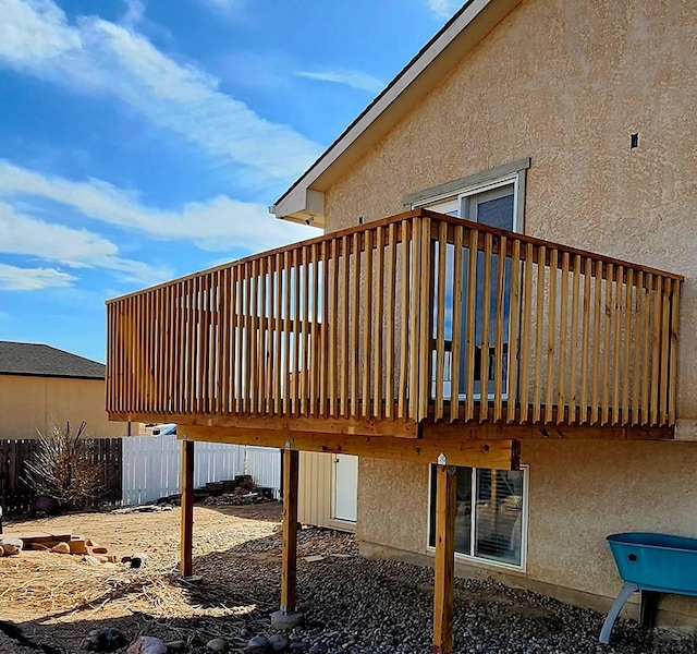 1044 S Los Charros Dr, Pueblo West, CO 81007 - view of property exterior featuring stucco siding, a deck, and fence