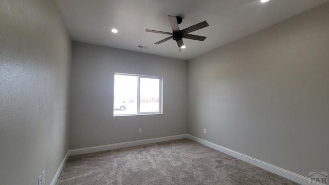 empty room with baseboards, visible vents, recessed lighting, ceiling fan, and carpet flooring